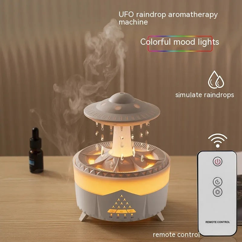 White cloud-shaped UFO raindrop humidifier diffuser with coloured night light on a wooden table.