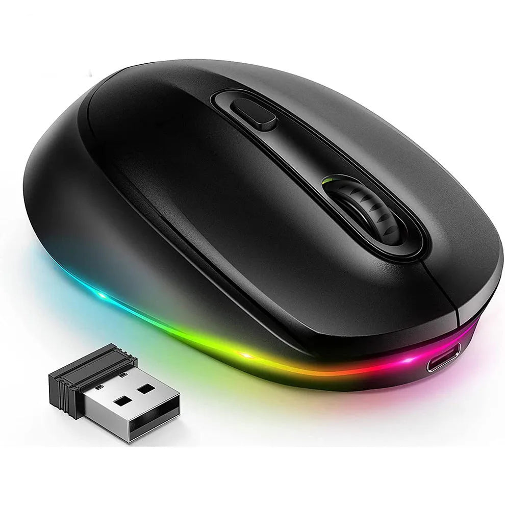 Compact white wireless mouse with ergonomic shape on a desk next to a laptop