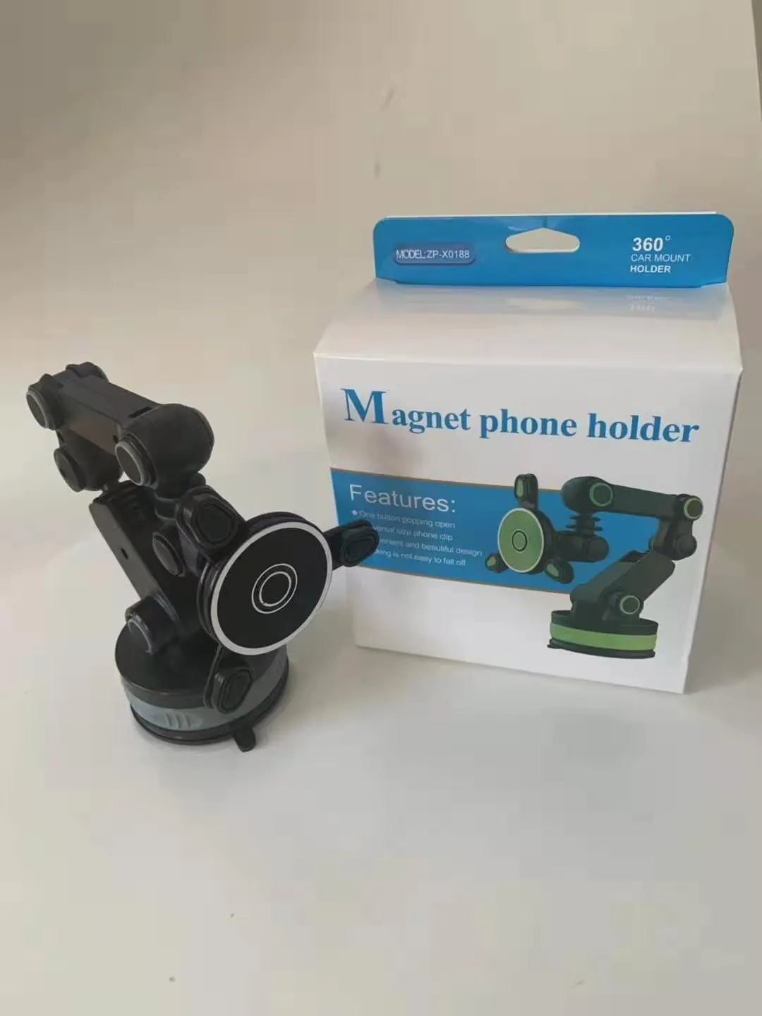 Gravity magnetic car phone holder with suction cup and adjustable arm mounted on dashboard