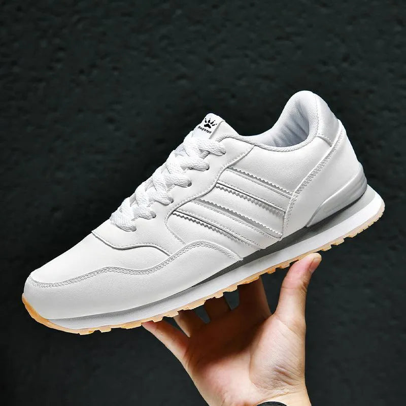 Men's black leather casual sports shoes with mesh lining and carved wing pattern design
