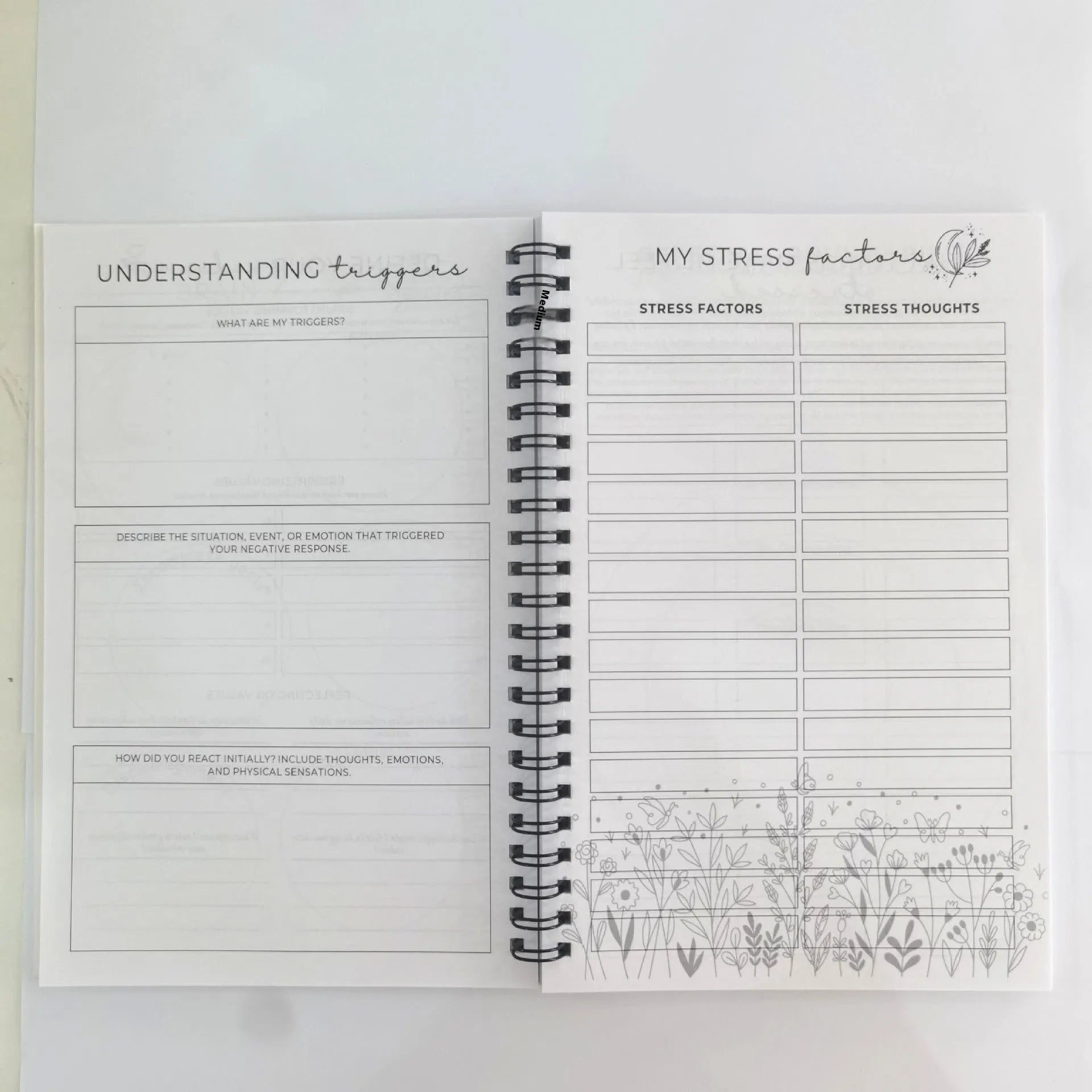 Pink paper cover coil-bound brain mental health notebook with 80g pages, open to blank pages