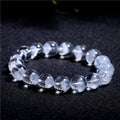 Women's natural white ghost bracelet with a white crystal pyramid charm and ruyi design elements.