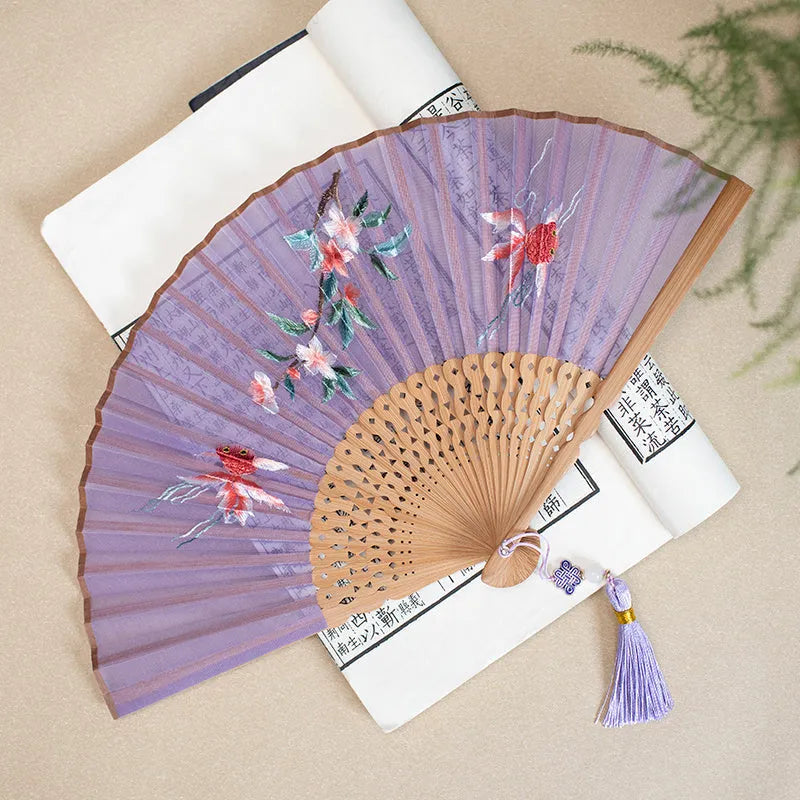 7-inch bamboo folding silk embroidered fan showing traditional Chinese embroidery designs