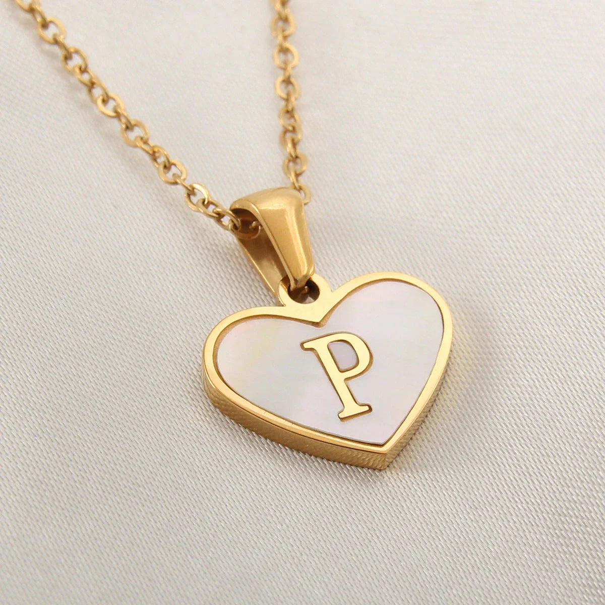 A personalized heart-shaped necklace with a 26-letter charm, crafted from high-quality stainless steel and gold plating.