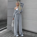 Women's velvet-look two-piece suit with drop-shoulder top and full-length trousers, available in grey or pink, sizes S to L
