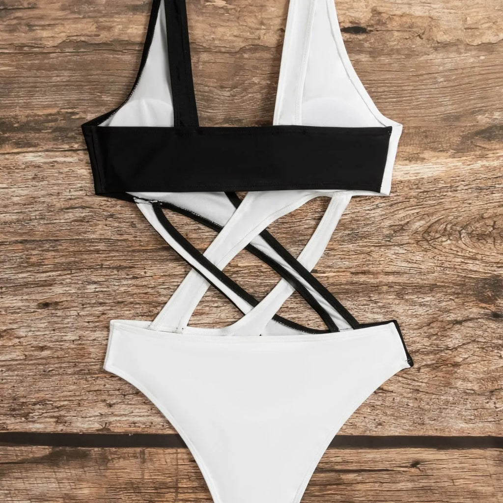 White women's one-piece swimsuit with colour-block panels and hollow-out decorative sections.