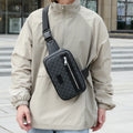 Men's black crossbody shoulder bag with printed chest design and sewing line detailing