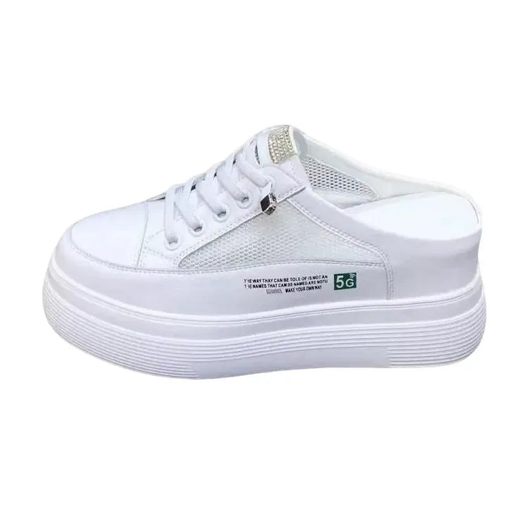 White women's platform trainers with mesh panels and a round toe on a rubber sole.