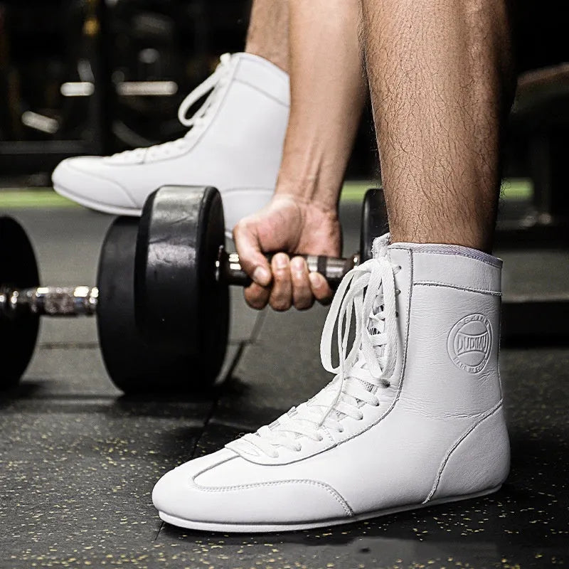 Professional black gold mesh boxing shoes with white leather panels and black detailing, shown in size 42.