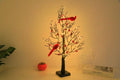 53cm red bird winding tree lamp with 60 lights on a plastic shell against a dark background