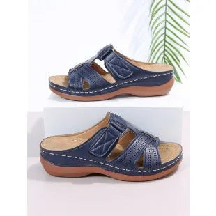 Women's red peep toe wedge sandals with a Velcro strap and hollow wedge heel.