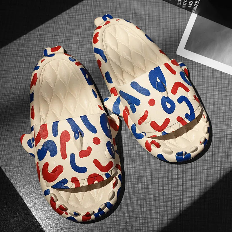 Pair of open-toe EVA slippers with a shark couple design on the footbed.