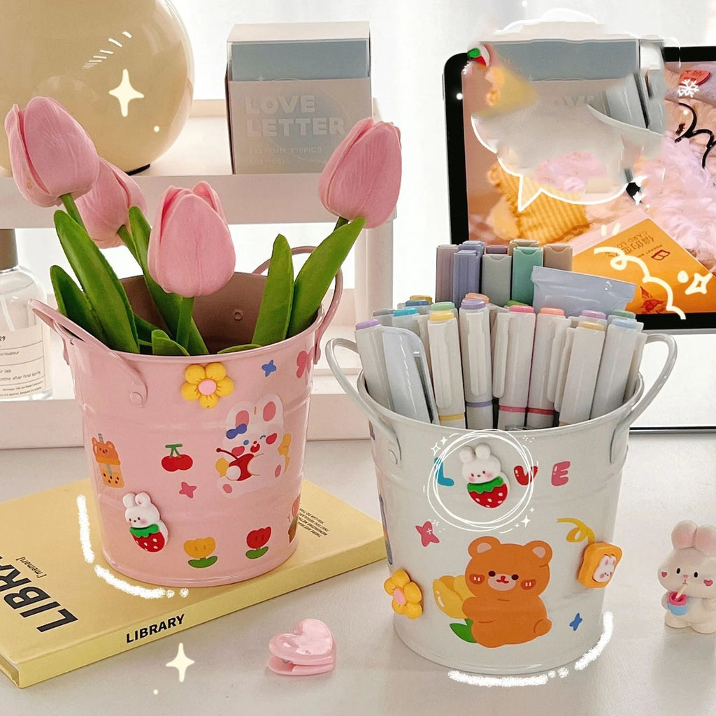 Round metal desk organiser pen holder in various colours including pink, green, red, white, and yellow.
