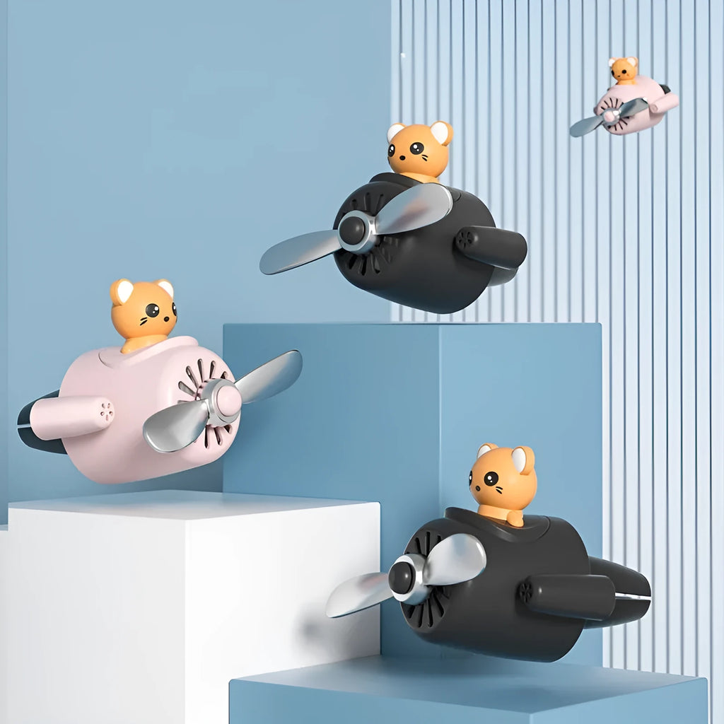 Cartoon aeroplane-shaped plastic clip for car air vent, includes fragrance slices, in black, blue, orange, or pink.