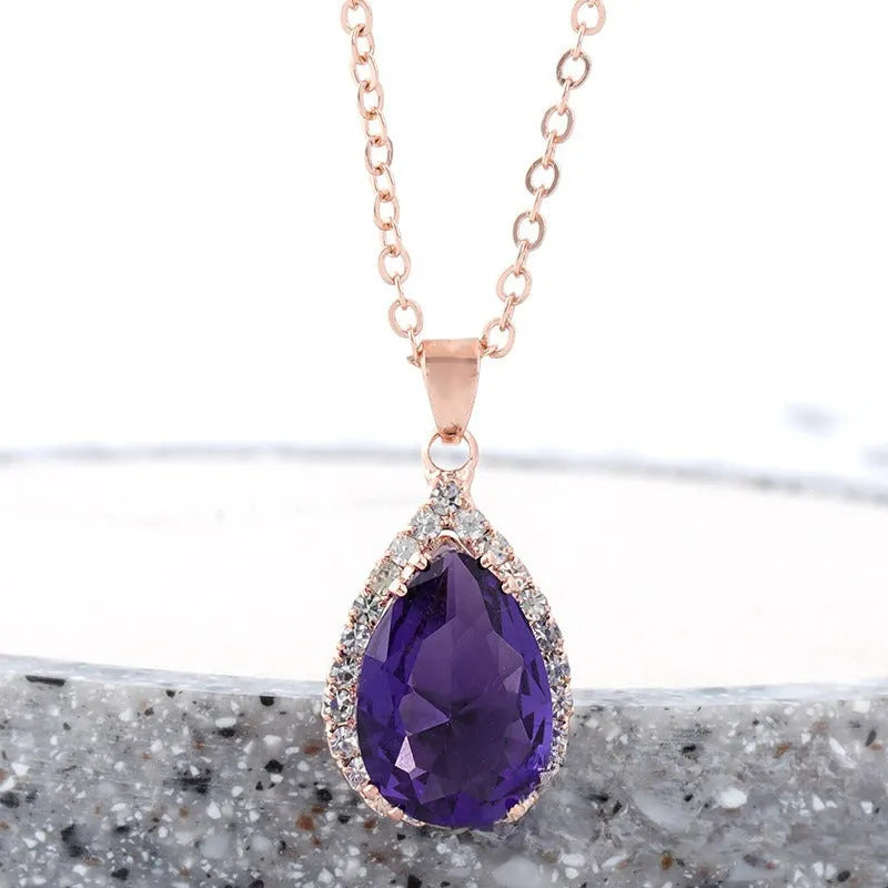 Women's pink alloy water drop necklace with geometric design and rose gold rhinestones on model