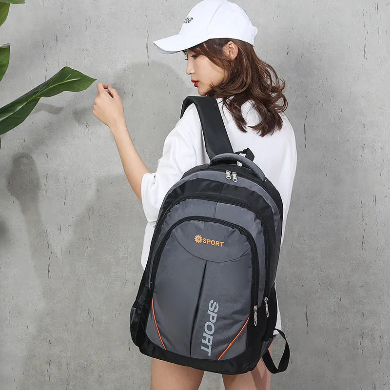 Large capacity nylon backpack in black with curved shoulder straps showing letter pattern design