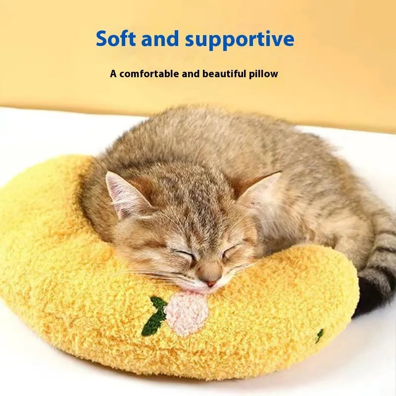 Blue and yellow cat sleeping mats with U-shaped neck pillows in moon and question mark shapes on a white background.