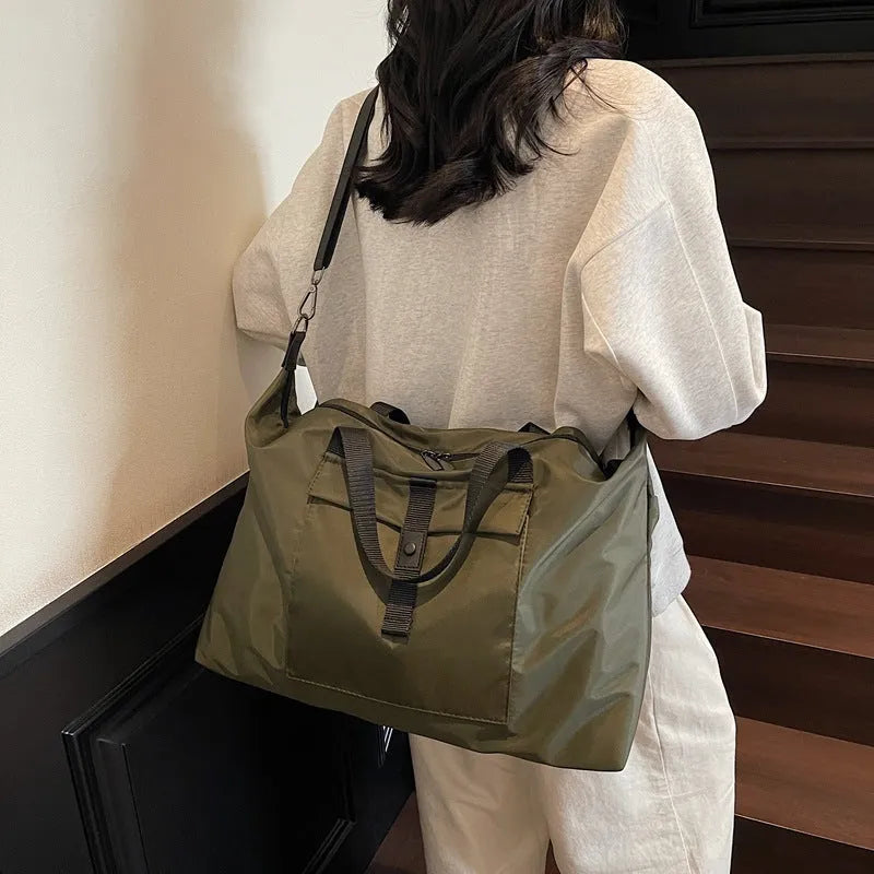 Grey one-shoulder Oxford cloth travel bag with 36-55L capacity and breathable lining