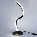 Advanced touch dimming desk lamp in white with white light mode on a bedside table