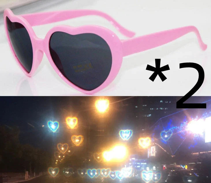 Heart-shaped glow-in-the-dark sunglasses in various vibrant colors, featuring a durable plastic frame and resin lenses for reliable UV protection.