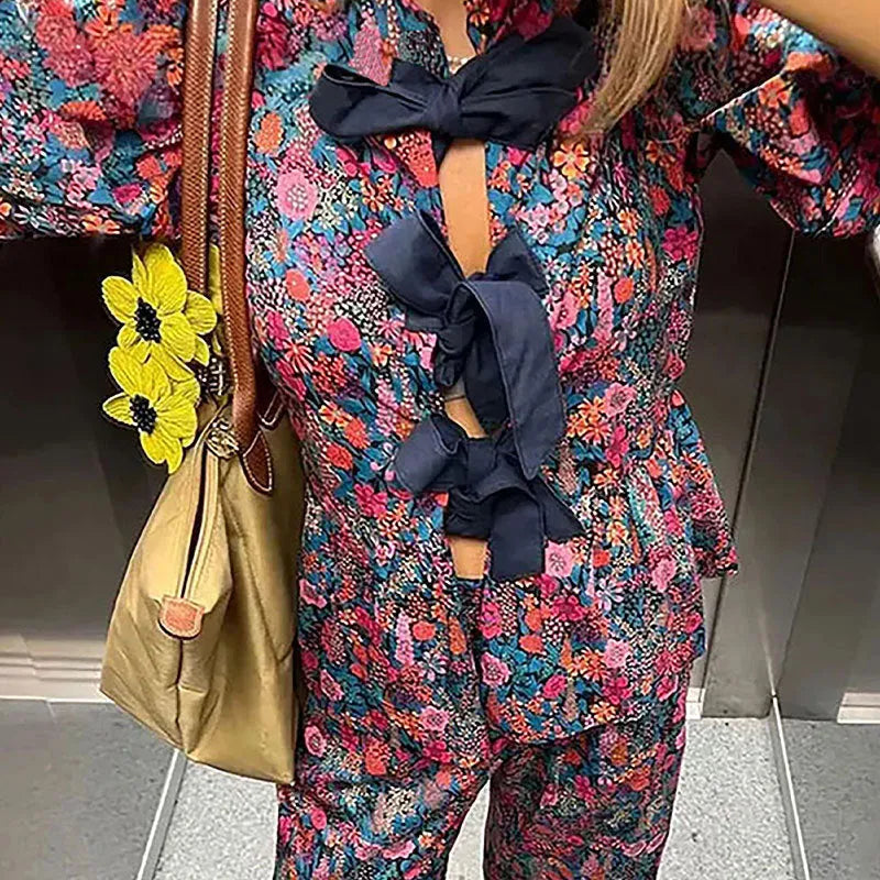 Floral print trousers suit with tie-neck puff sleeve blouse and matching trousers