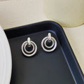 Geometric irregular round ring earrings in electroplated gold colour with exotic style mixed material construction