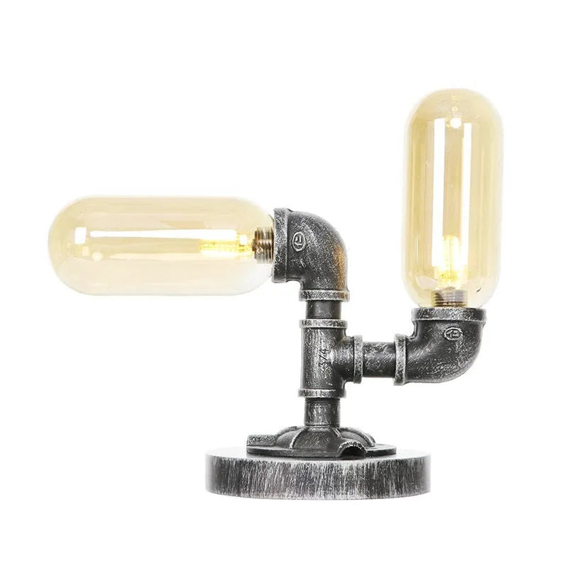 Retro iron art water pipe desk lamp with silver ancient finish on a wooden desk