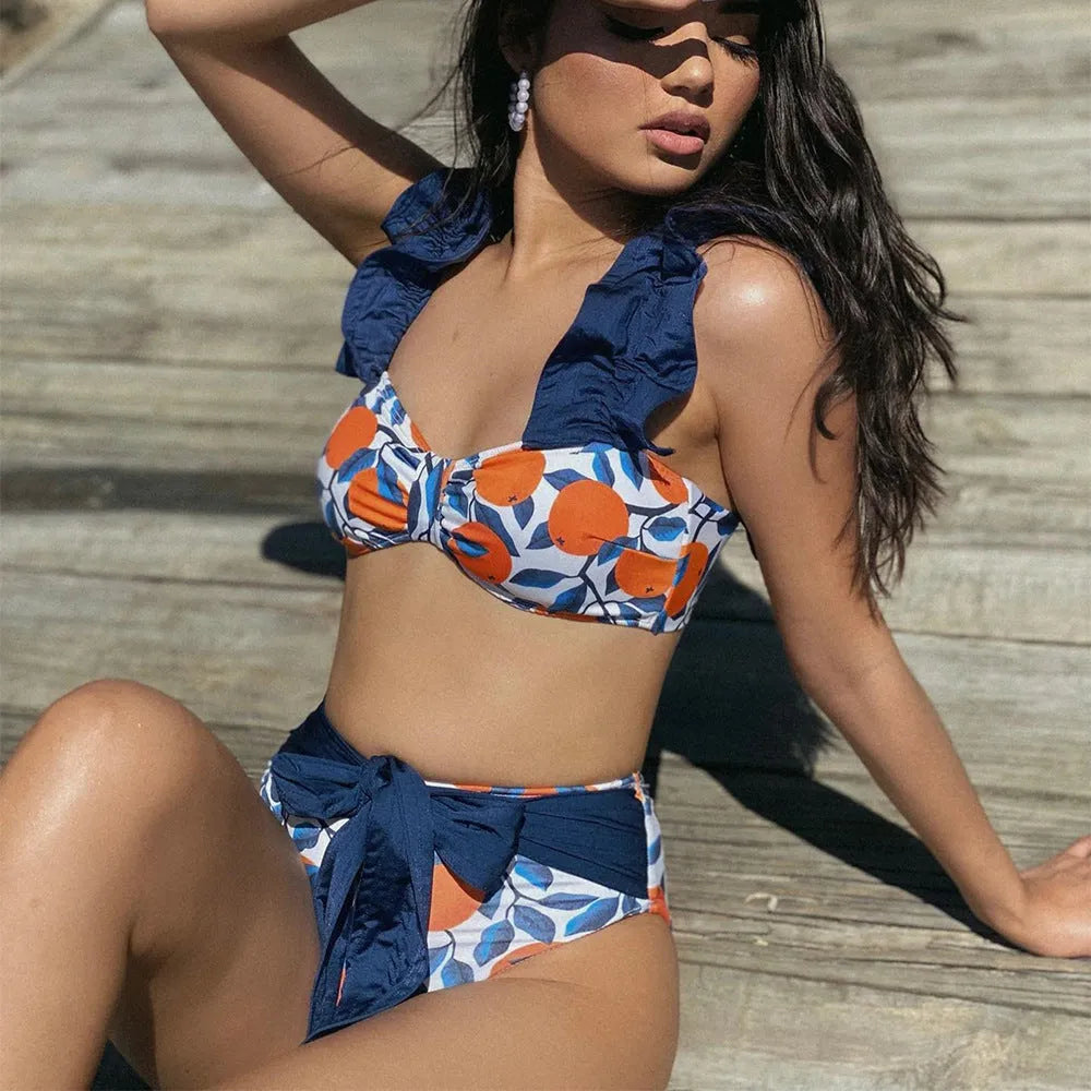 Blue leaf orange printed high waisted bikini swimsuit for women on mannequin