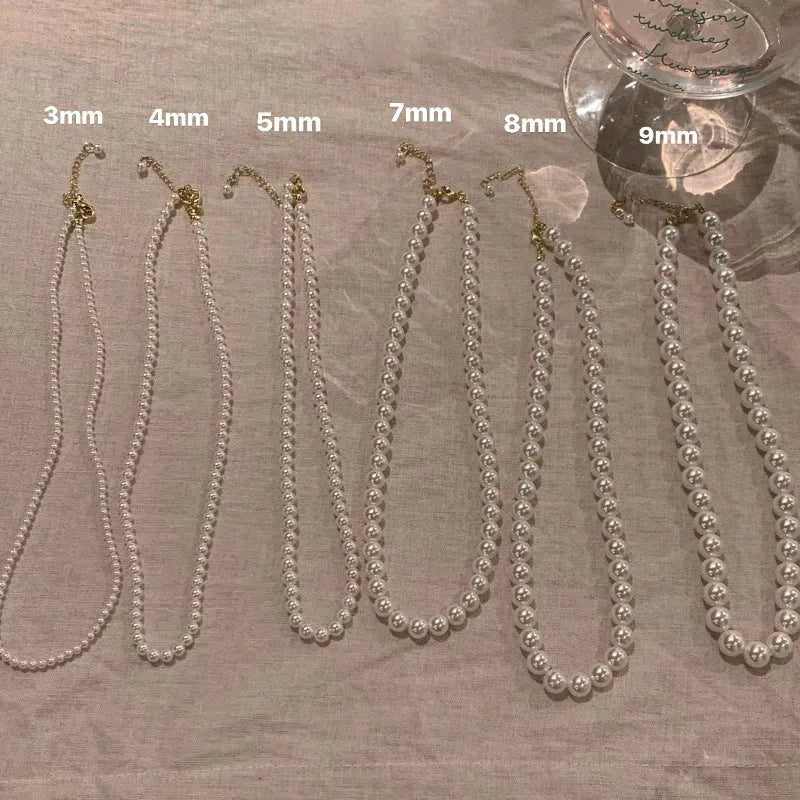 Unisex magnetic sweater necklace with mother pearl shellfish pendant and organic glass setting on electroplated chain, available in multiple colours