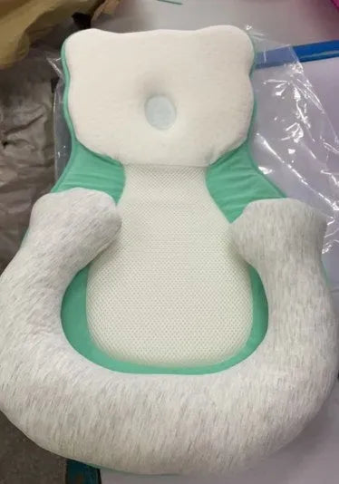Folded portable baby travel bed with a soft beige cotton sleep cushion for newborns