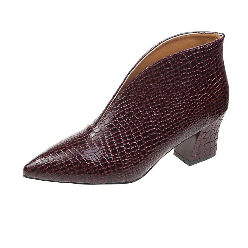 Women's black ankle boots with V-cut design, embossed texture, and chunky heel