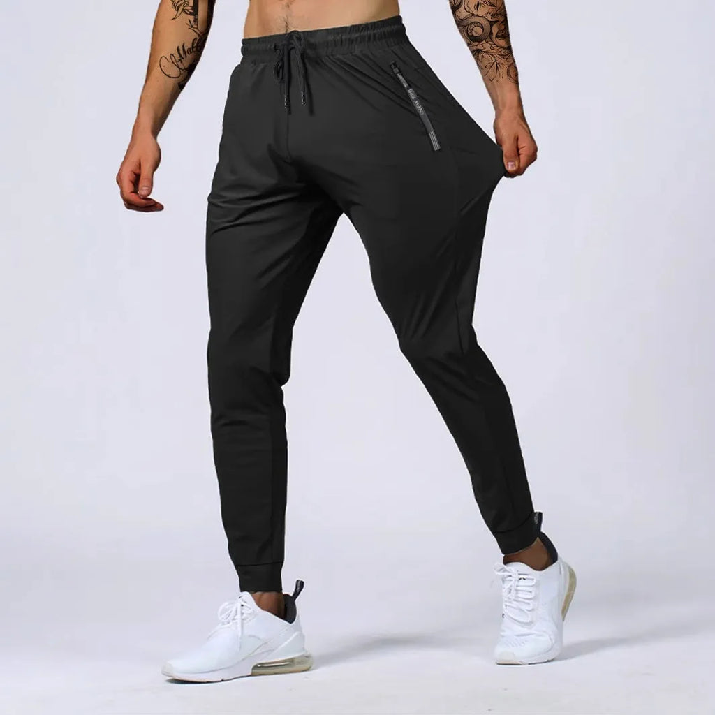 Men's jogging sports pants in nylon blend, mid waist loose fit, available in black gray khaki blue sizes L to 7XL