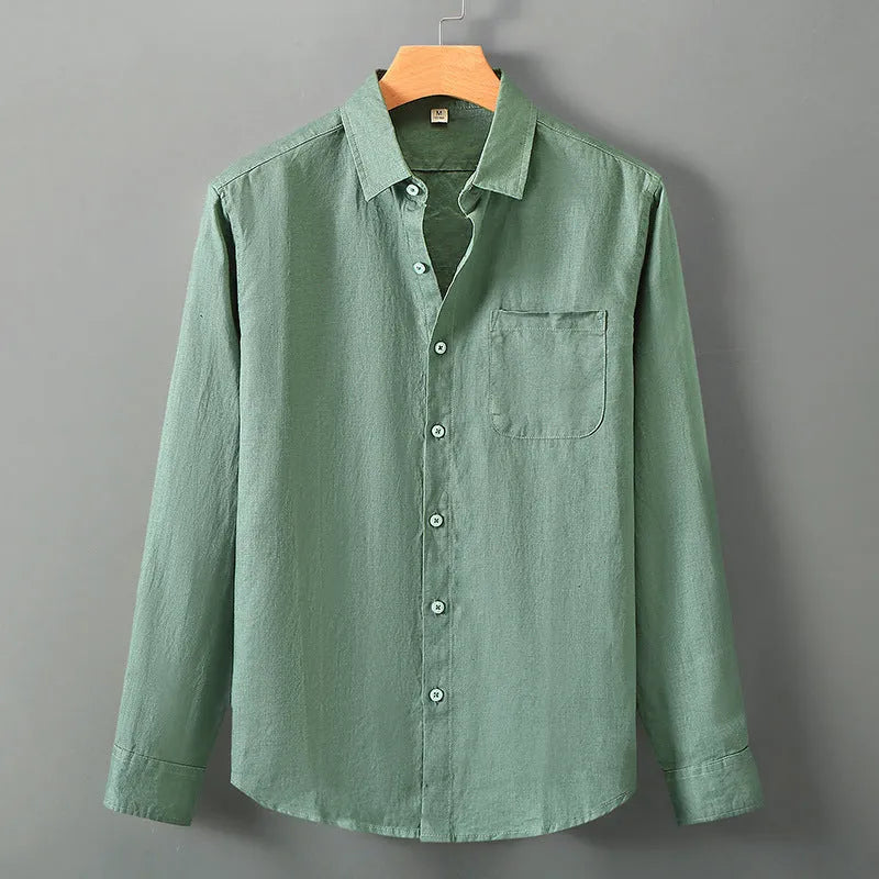 Loose long sleeve linen shirt in a cardigan style on a hanger, shown in light sapphire blue colour.