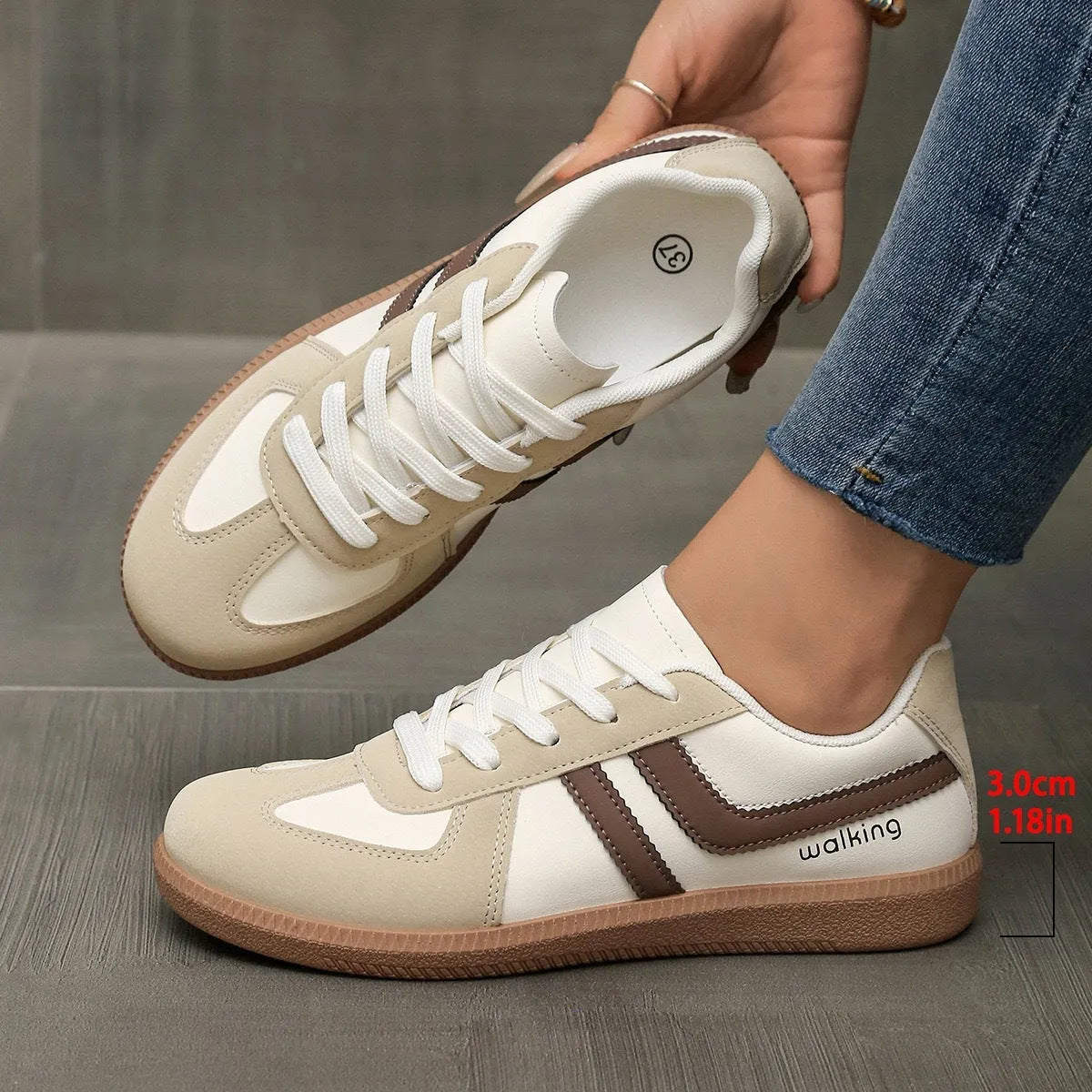 Plus size low-top sneaker in artificial PU with flat rubber sole and lace-up front, shown in multiple colour options.
