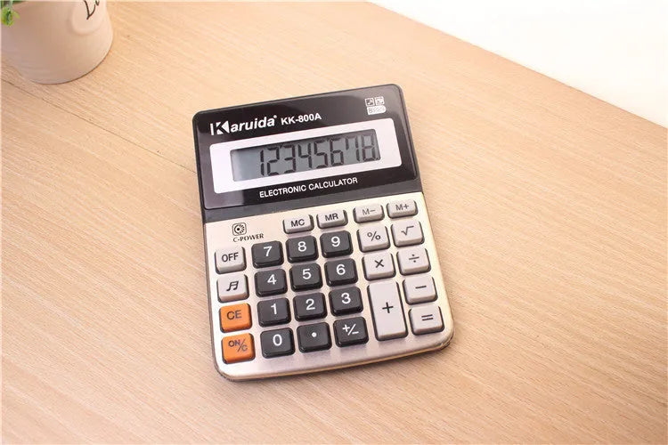 Silver aluminium desktop calculator with compact dimensions approximately 14.5 x 11 x 2.5 cm on a desk