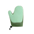 Dark blue pet hair removal glove for grooming dogs and cats on a fabric sofa.