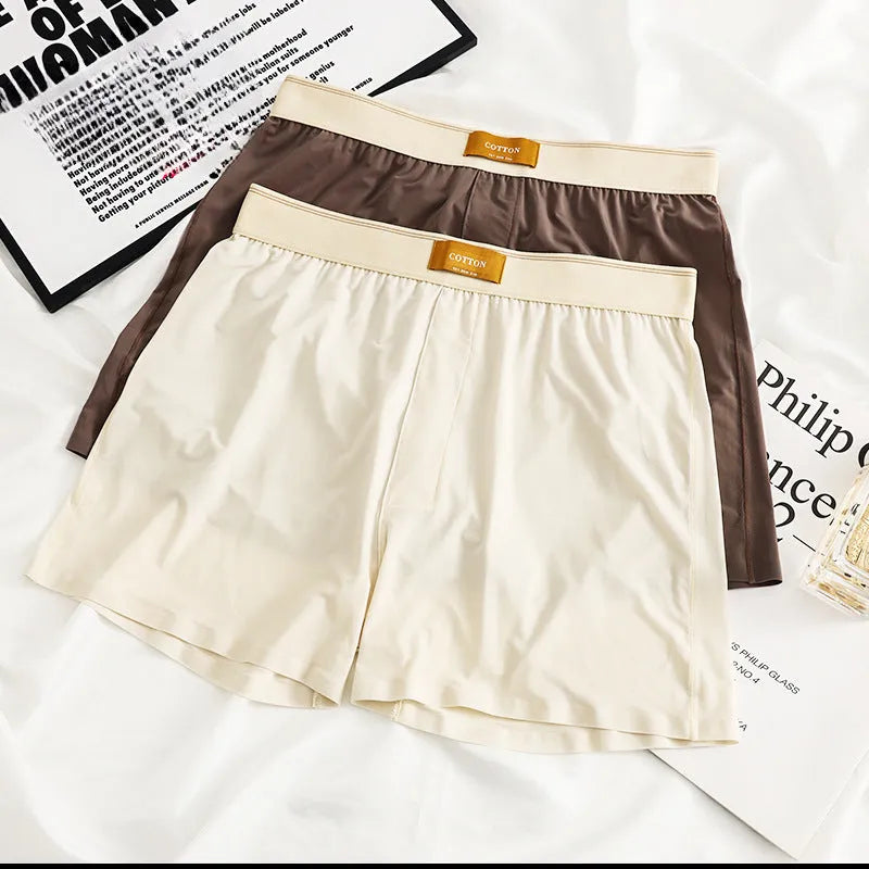 Pack of three pairs of men's solid colour loose fit ice silk nylon underwear on a white background.