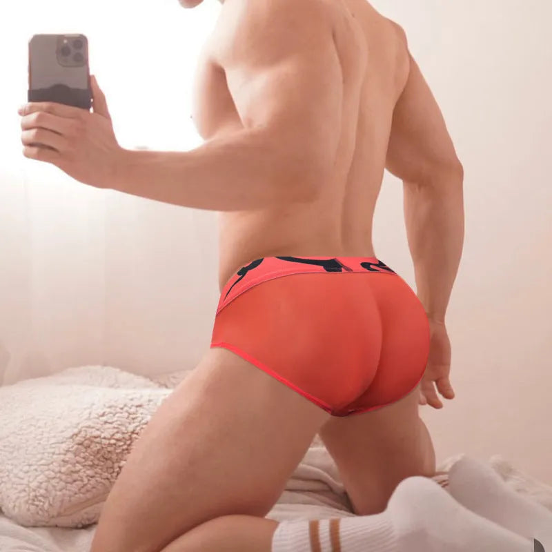 Men's solid colour modal boxer shorts showing low waist design in black, pink, and red options
