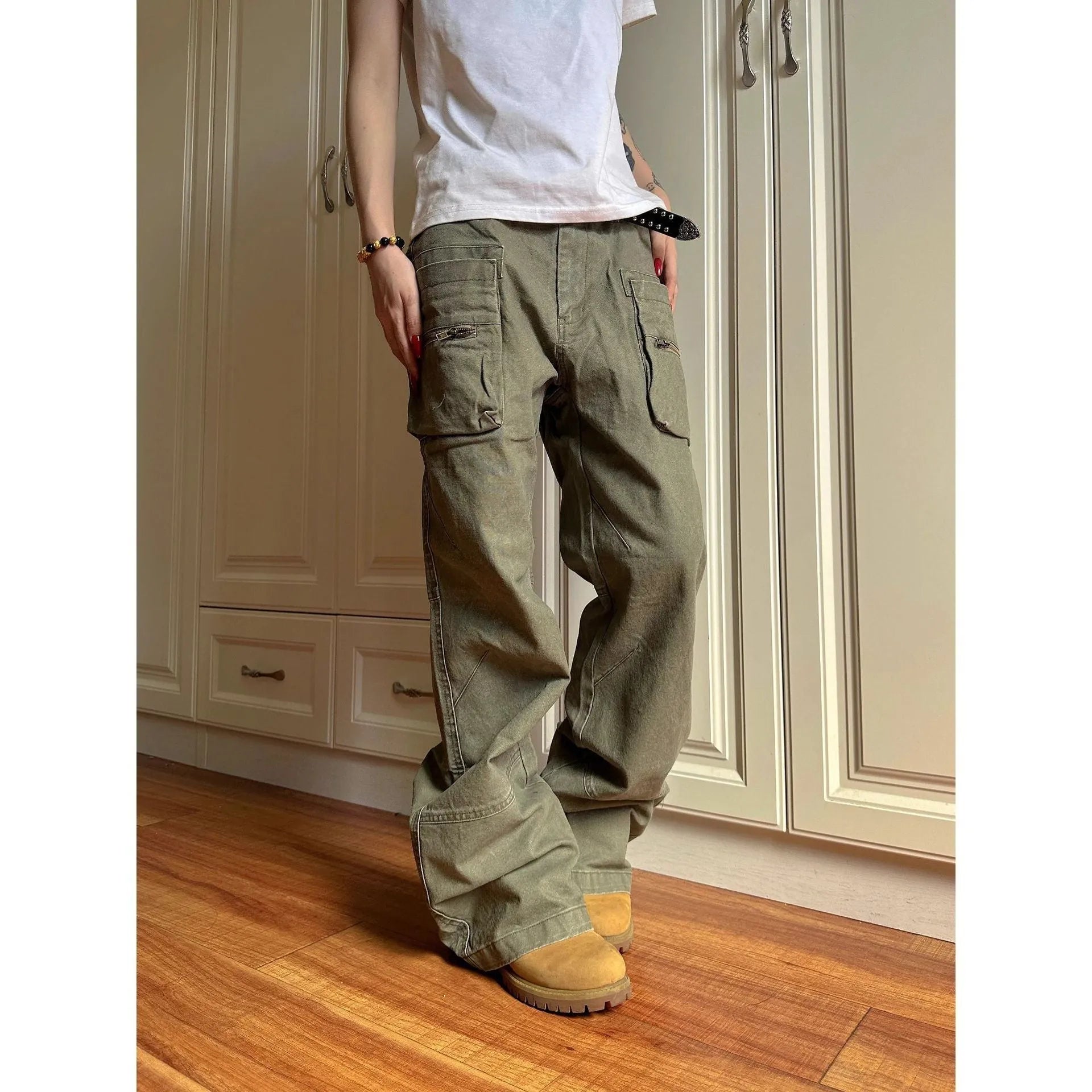 Green and black cotton casual trousers with double zipper detail and pockets on a mid-waist design.