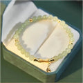 Bamboo-themed bracelet with ruyi motif and coloured flower glass beads on an electroplated chain.