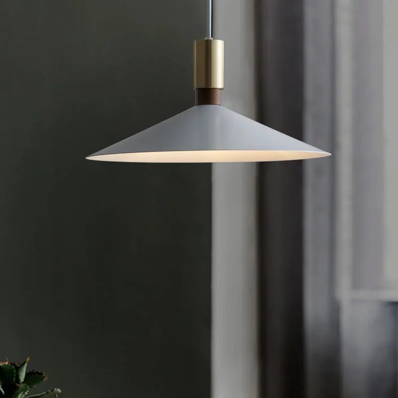 Modern round single-headed iron bar lamp in black, shown hanging over a dining table.
