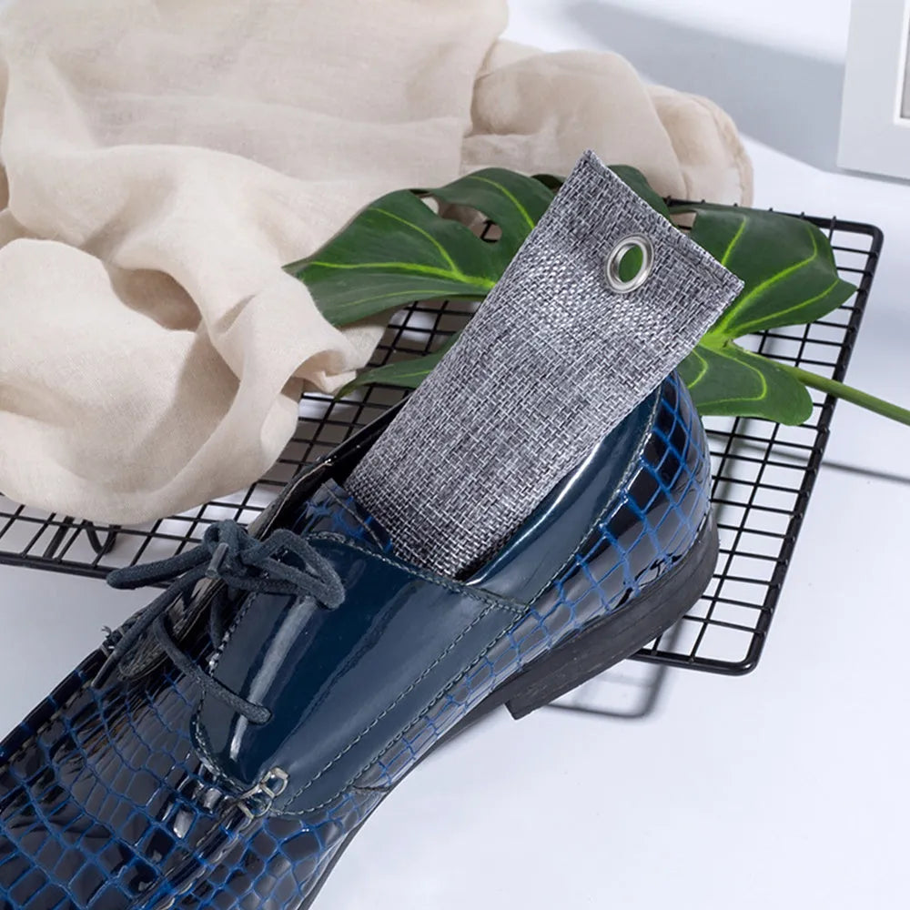 Set of four bamboo charcoal deodorising bags in different colours for shoe and household odour absorption.