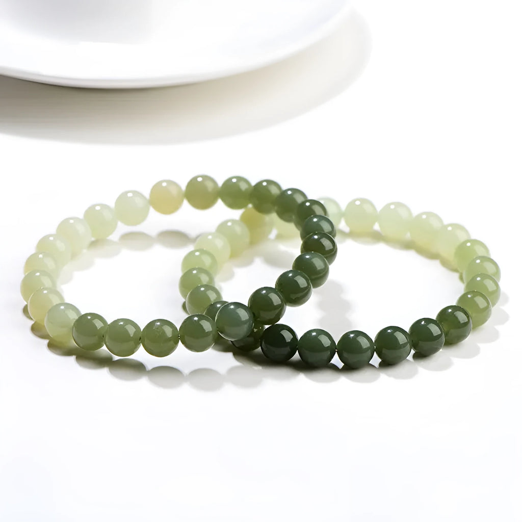 Natural clear water Hetian jade ball bracelet with round and barrel bead options.