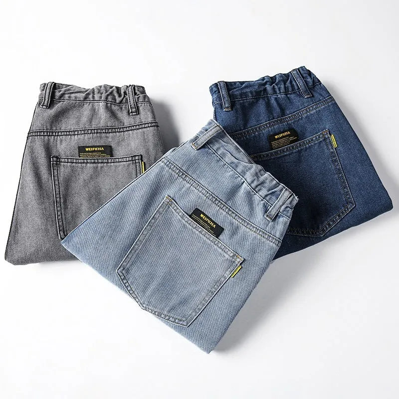 Men's loose straight-cut cotton jeans in dark blue, shown in a casual setting
