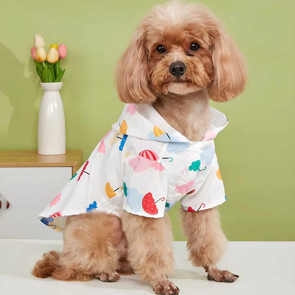 Colourful cartoon umbrella pattern dog raincoat on a model, showing four leg openings and polyester fabric.