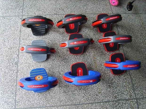 Black red plastic high speed drift skateboard with whirlwind wheels on pavement