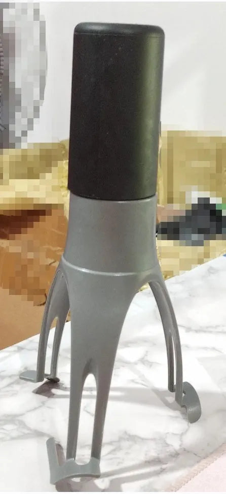 Green Uutensil Stirr automatic handheld mixer for pots, showing its compact size.