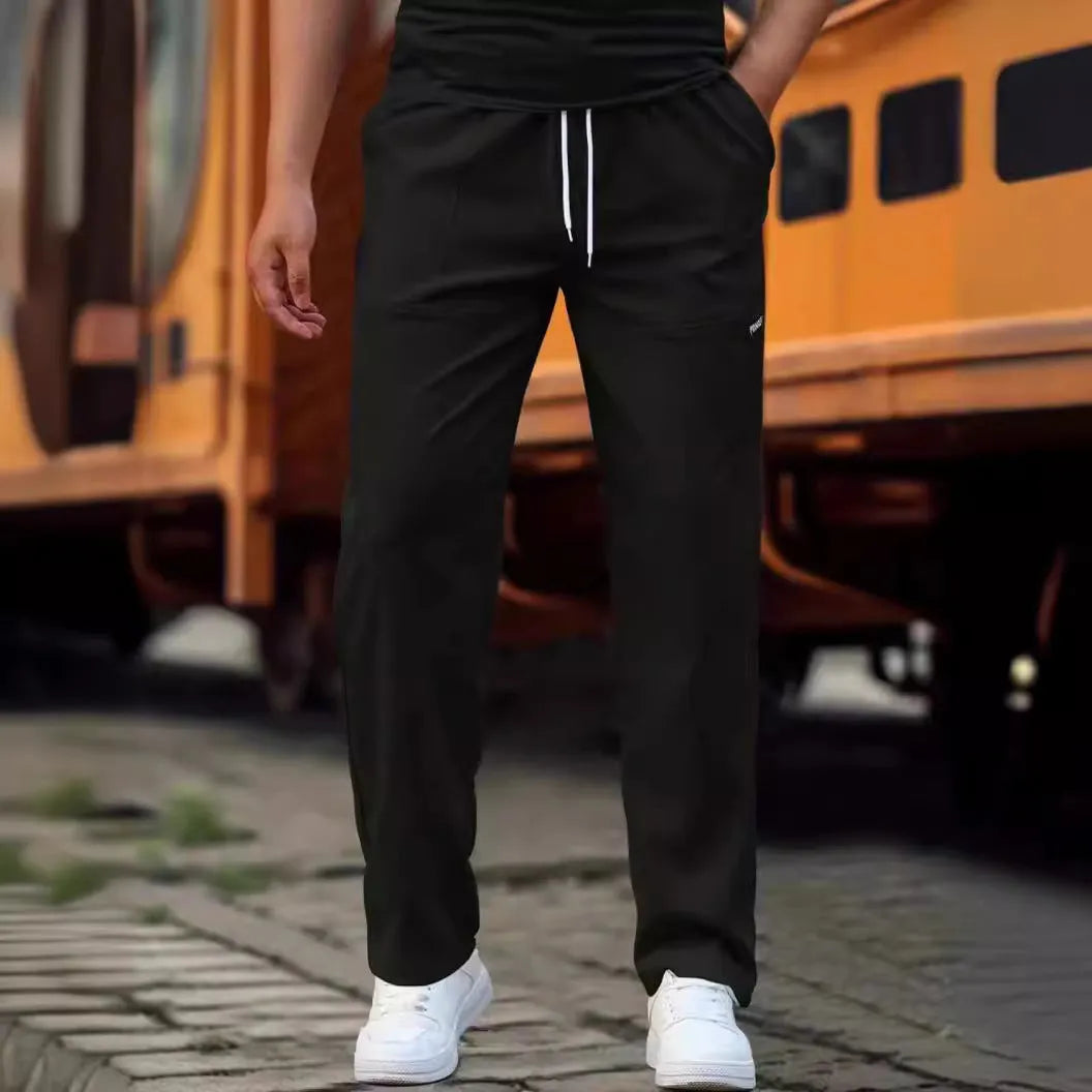 Men's light grey casual chino-style trousers made from polyester for spring and autumn wear.