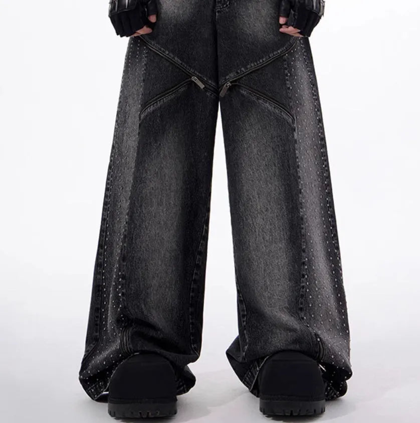 Black and grey washed denim wide leg trousers with structural zipper detail and matching vest, laid flat.
