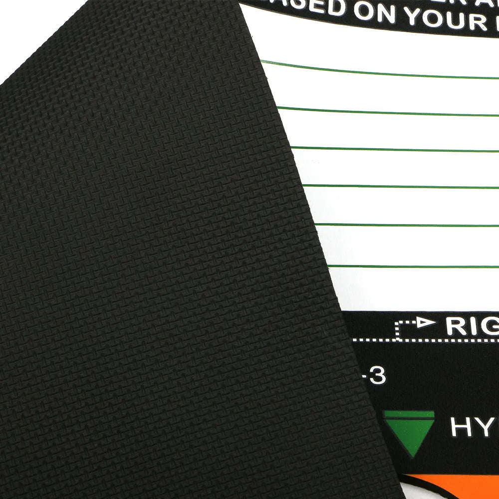 Black neoprene golf swing posture correction training pad on a green surface.